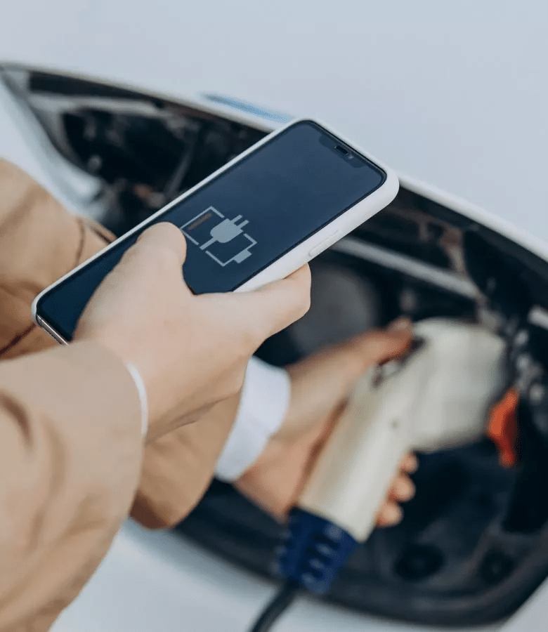Person using their phone to check the status of the battery level on their vehicle